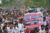 Rohingya refugees gather to mark the seventh anniversary of their fleeing from neighboring Myanmar to escape a military crackdown in 2017 during heavy monsoon rains in Cox's Bazar, Bangladesh on Aug. 25, 2024. (Reuters/Mokammel Mridha)