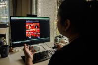 Ms Ying Lao, who runs the Salween Institute for Public Policy, a Myanmar-focused think tank, showing all-male panel posters that she has compiled on her computer. PHOTO: NYTIMES