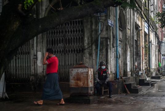 A member of the Myanmar security forces sits along a street in Yangon on July 19.Source: AFP/Getty Images