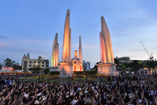 Anti-government protesters hold up three-finger salutes at a rally by the Democracy Monument in Bangkok on August 16, 2020. 