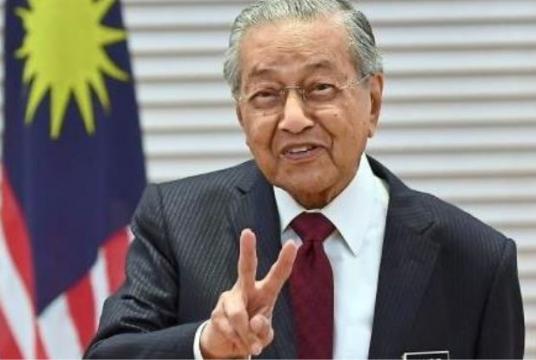 Dr Mahathir gesturing to the media after the press conference at the Perdana Building in Putrajaya. — Bernama