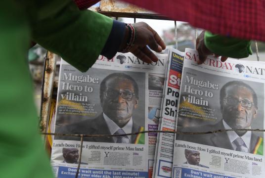 A man buys a daily newspaper at a stand on the streets of Nairobi, on September 7, 2019, following the death of former Zimbabwe president Robert Mugabe, guerrilla hero turned despot who ruled Zimbabwe for 37 years. Mugabe, 95, passed away on September 6, 2019 in Singapore, where he had been hospitalised in April. First heralded as a liberator who rid the former British colony Rhodesia of white minority rule, Mugabe used repression and fear to govern until he was finally ousted by his previously loyal genera