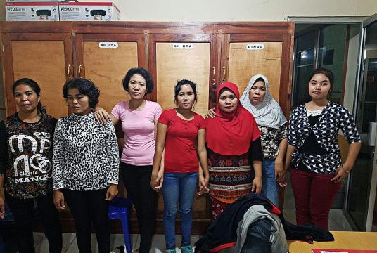 Seven women migrant workers from West Nusa Tenggara, who were rescued from a human trafficking network, pose for a picture together. (Courtesy of the West Nusa Tenggara Police/File)