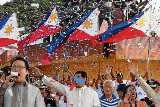 UNFAMILIAR Confetti fall on a group celebrating the 33rd anniversary of People Power at the People Power Monument on Edsa. —NIÑO JESUS ORBETA