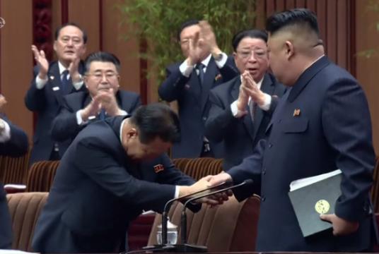 North Korean leader Kim Jong-un shakes hands with Choe Ryong-hae, who was named president of the Presidium of the Supreme People’s Assembly at the first session of the country’s rubber-stamp parliament Friday. The meeting was broadcast by state-run Korean Central Television on Saturday. (Yonhap)