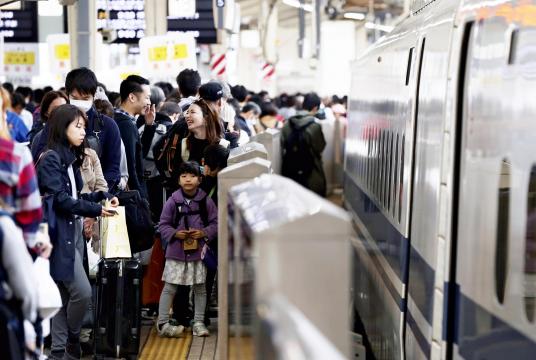 Travelers are seen on a platform of the Tokaido Shinkansen line at Tokyo Station at 9 a.m. on Saturday. 