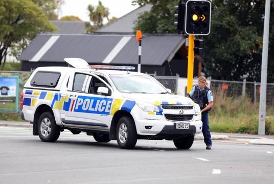 A police officer cordons off a street near a mosque after a mass shooting in Christchurch, New Zealand on March 15. A gunman opened fire inside the Al Noor Mosque during afternoon prayers, causing multiple fatalities. (AFP/Radio New Zealand)