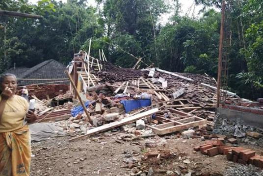 A resident of Montong Gading district, East Lombok, stands by her collapsed house after an earthquake on Sunday. (Courtesy of BPBD NTB/-)