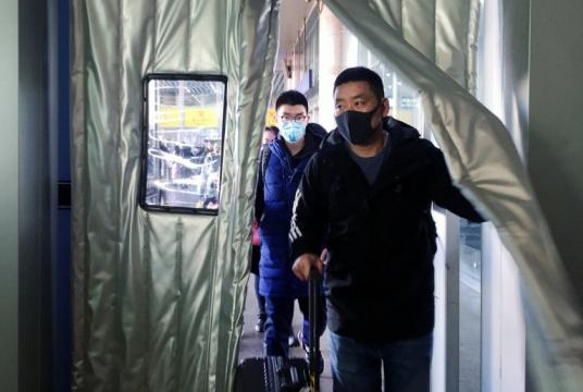 Near, far, wherever you are: Passengers wearing masks enter the Beijing West Railway Station in Beijing on Monday. Chinese authorities said the number of patients of an outbreak of a new coronavirus in the country had tripled and a third person had died. (Reuters/Stringer)
