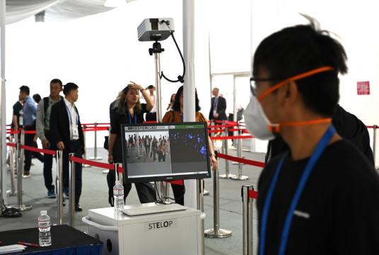 Visitors walk through temperature scanners at the Singapore Airshow, amid fears over the spread of the new coronavirus, in Singapore on Feb. 13. (AFP/ROSLAN RAHMAN) 