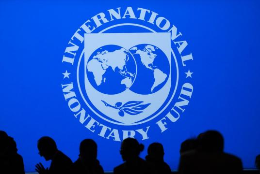 People arrive for the IMF/World Bank Annual Fall Meetings Plenary Session in Washington, DC, on October 18, 2019. (AFP/Andrew Caballero Reynolds)