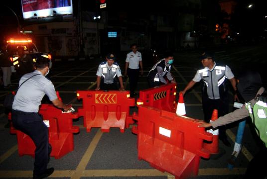 Transportation agency and traffic police personnel work to divert traffic on major roads in Tegal, Central Java, on March 22, 2020. (Antara/Oky Lukmansyah)