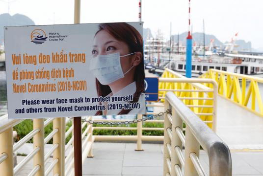 Coronavirus awareness banner is seen at a locked tourism port at Ha Long bay after the Vietnamese government eased the lockdown following the coronavirus disease (COVID-19) outbreak, in Quang Ninh province, Vietnam May 19, 2020. (REUTERS/Kham) 
