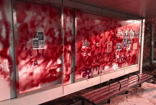 This photo taken and received courtesy of an anonymous source via Facebook on April 14, 2021 shows a bus stop covered in red spray paint as part of a (AFP/Handout)