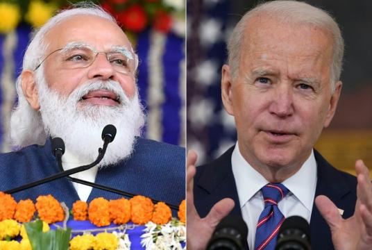 This combination of pictures created on April 26, 2021 shows a handout photograph taken on December 15, 2020 and released by the Indian Press Information Bureau (PIB) of Prime Minister Narendra Modi during the foundation stone ceremony of various development projects in Kutch. and a file photo taken on April 2, 2021, of US President Joe Biden(R) speaking in the State Dining Room of the White House in Washington, DC. (AFP/Mandel Ngan/Indian Press Information Bureau)