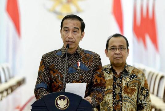 This handout picture taken on September 20, 2019 and released by the Presidential Palace shows Indonesia's President Joko “Jokowi“ Widodo (left) with Minister of State Secretariat Pratikno (right) as he announces a delay in passing a new law that would outlaw gay and pre-marital sex at the Presidential Palace in Jakarta. (AFP/Presidential Palace)