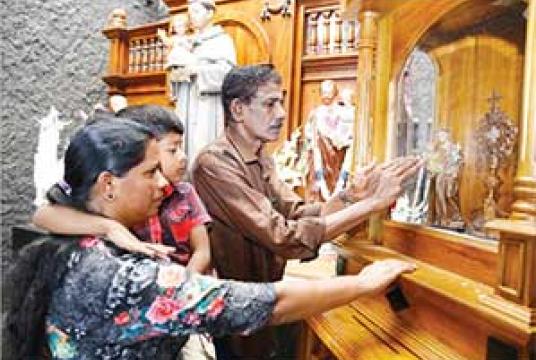 A section of St. Anthony’s Shrine at Kochchikade was opened for devotees yesterday after Easter Sunday’s suicide attack killing many. Many devotees turned up yesterday to pray at Sri Lanka’s holiest shrine. Pic by Nishan S. Priyantha