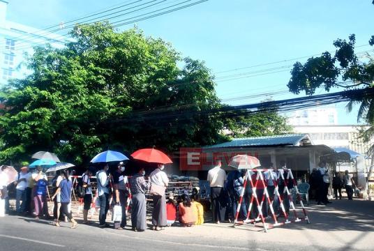 Photo - People are waiting in line in front of the passport issuing office in Yangon in 2021.