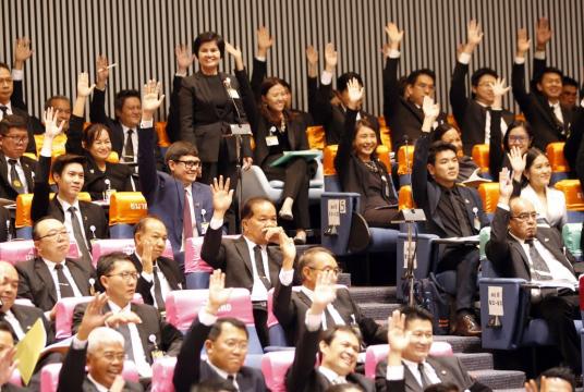 Some of the Thai members of the House raise their hands to support the leader of the Future Forward Party, Thanathorn Juangroongruangkit (not pictured), in pole position to be the new prime minister. // EPA-EFE PHOTO