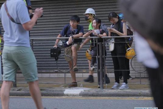 In this July 28, 2019 photo, Joshua Wong Chi-fung (first left, back) attends a protest in Hong Kong, south China. (PHOTO / XINHUA)