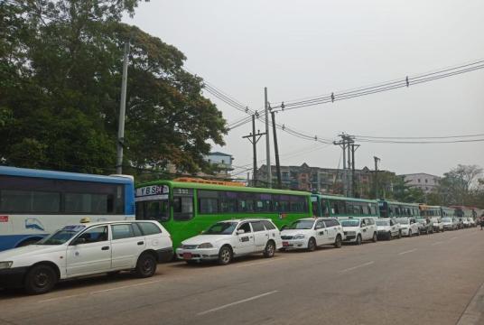 Vehicles wait in line in front of a CNG station in Yangon Region