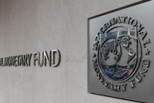 In this March 27, 2020 photo, an exterior view of the building of the International Monetary Fund (IMF), with the IMG logo, is seen in Washington, DC. (Olivier DOULIERY / AFP)
