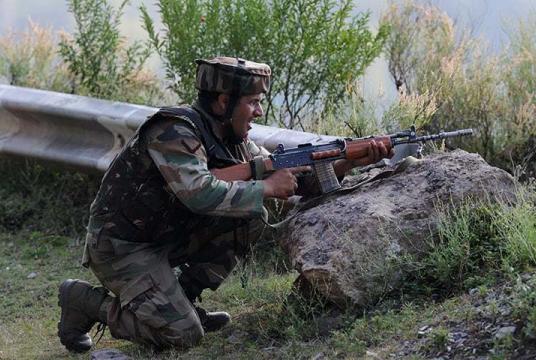 An Indian army soldier takes up position near the Line of Control. — AFP/File