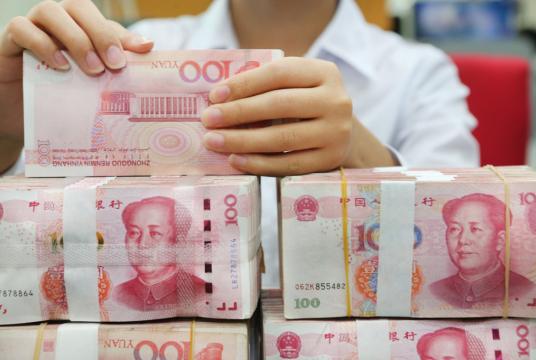 A Chinese clerk counts RMB (renminbi) yuan banknotes at a branch of Bank of China in Nantong city, East China's Jiangsu province, July 23, 2018. [Photo/IC]