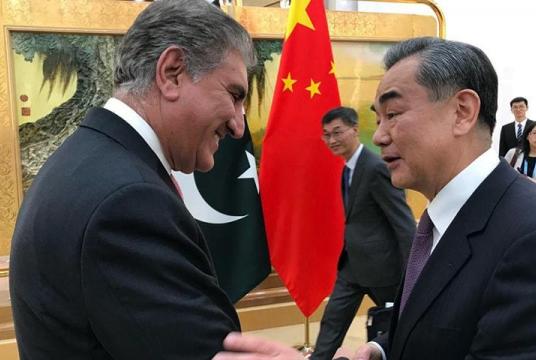Foreign Minister of the People's Republic of China Wang Yi is pictured greeting Minister for Foreign Affairs Shah Mahmood Qureshi prior to meeting held between the two in Beijing on April 24. — Foreign Office