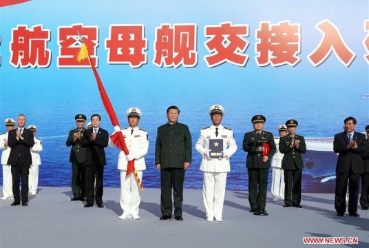 President Xi Jinping, also general secretary of the Communist Party of China Central Committee and chairman of the Central Military Commission, presents the People's Liberation Army flag and the naming certificate to the captain and political commissar of aircraft carrier Shandong, respectively, during the commissioning ceremony of China's first domestically built aircraft carrier at a naval port in Sanya, South China's Hainan province, Dec 17, 2019. [Photo/Xinhua]