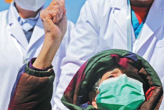 An 83yearold patient who recovered from novel coronavirus pneumonia gestures as she is discharged from Leishenshan Hospital in Wuhan, Hubei province, on Tuesday. WANG JING / CHINA DAILY 