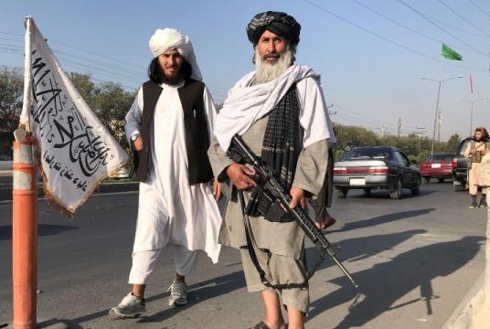 Taliban fighters stand outside the Interior Ministry in Kabul on August 16. — Reuters