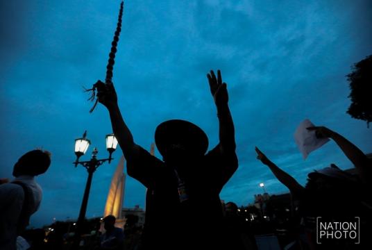 Pro-democracy protesters join a Harry Potter-themed gathering at Democracy Monument on Monday night. In what was viewed as a landmark gathering, protesters for the first time openly raised the issue of the monarchy's role.