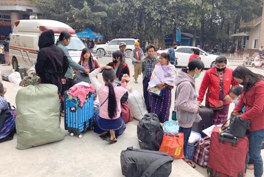 Myanmar workers who returned home are seen at Muse border gate on 15 February. 