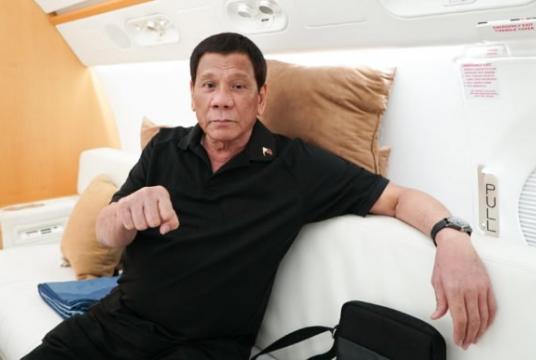 President Rodrigo Roa Duterte flashes his signature pose while on a plane bound for the People’s Republic of China at the Villamor Air Base in Pasay City on August 28, 2019. (Photo by KING RODRIGUEZ / Presidential Photographers Division) 