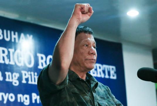 President Rodrigo Roa Duterte raises his fist while delivering a speech during the 121st Philippine Independence Day celebration at the 6th Infantry Battalion Grounds in Malabang, Lanao del Sur on June 12, 2019. ALBERT ALCAIN/PRESIDENTIAL PHOTO