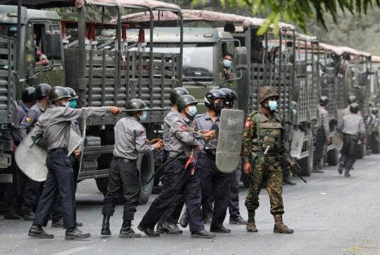 Police and soldiers are seen during a protest against the military coup in Mandalay on Feb 20, 2021.PHOTO: REUTERS