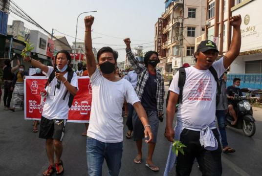 Demonstrators raise their fists as they march during an anti-military coup protest in Mandalay, Myanmar, on April 12, 2021.PHOTO: EPA-EFE