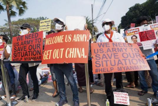 Anti-coup protesters outside the Singapore embassy in Yangon on Feb 18 holding up signs asking for US army to save Myanmar.PHOTO: KYAW ZA