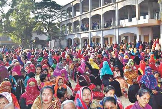 Awaiting free rice distribution by Abdur Rahman Bodi, widely known as a patron of yaba trade, hundreds of women and children gather in Chowdhury Para area of Teknaf. /The Daily Star