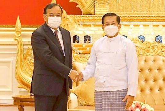 Myanmar State Administration Council Chairman Senior General Min Aung Hlaing shakes hands with Cambodian Foreign Minister and ASEAN Special Envoy to Myanmar Prak Sokhonn during a meeting in Naypyitaw, Myanmar. PHOTO: AP