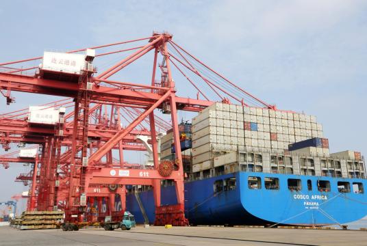An ocean shipping cargo ship unloads cargoes at the container terminal of the Port of Lianyungang, East China's Jiangsu province, on July 14, 2020. [Photo/Xinhua]