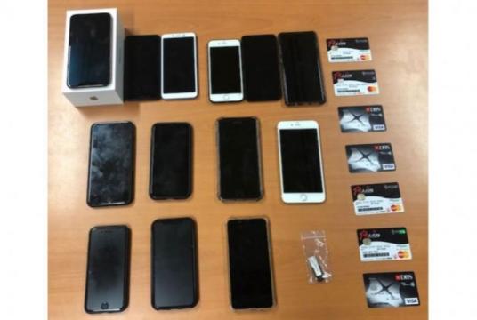 Mobile phones, debit cards and a thumb drive were seized as case exhibits.PHOTO: SINGAPORE POLICE FORCE