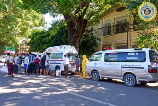 Heath workers taking Covid-19 patients to hospital in Mandalay Region 
