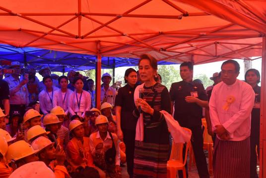 State Counsellor Aung San Suu Kyi delivering a speech to construction workers at Myaungmya Bridge site.