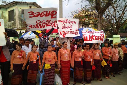 Some locals holding placards in front of Pale Yadanar hall where State Counsellor met with people.