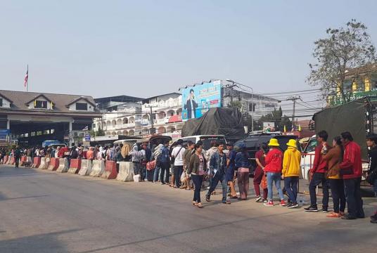 Myanmar migrant workers are seen at the Friendship Bridge in Myawady