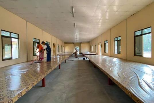 Beds are prepared to keep COVID-19 suspects in quarantine in a building at a sports ground in Sagaing
