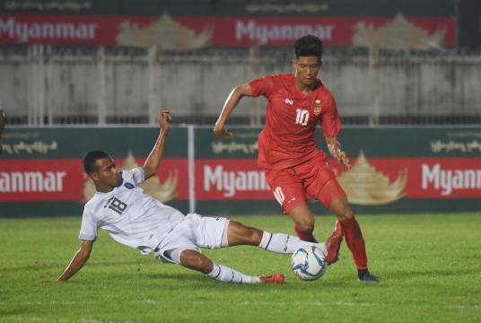 Striker Win Naing Tun tried to run past a Timor-Leste defender (Photo-Nyi Nyi Soe Nyunt)