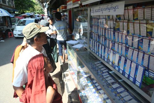 People who are looking at lottery tickets to try their luck (Photo-Kyi Naing)